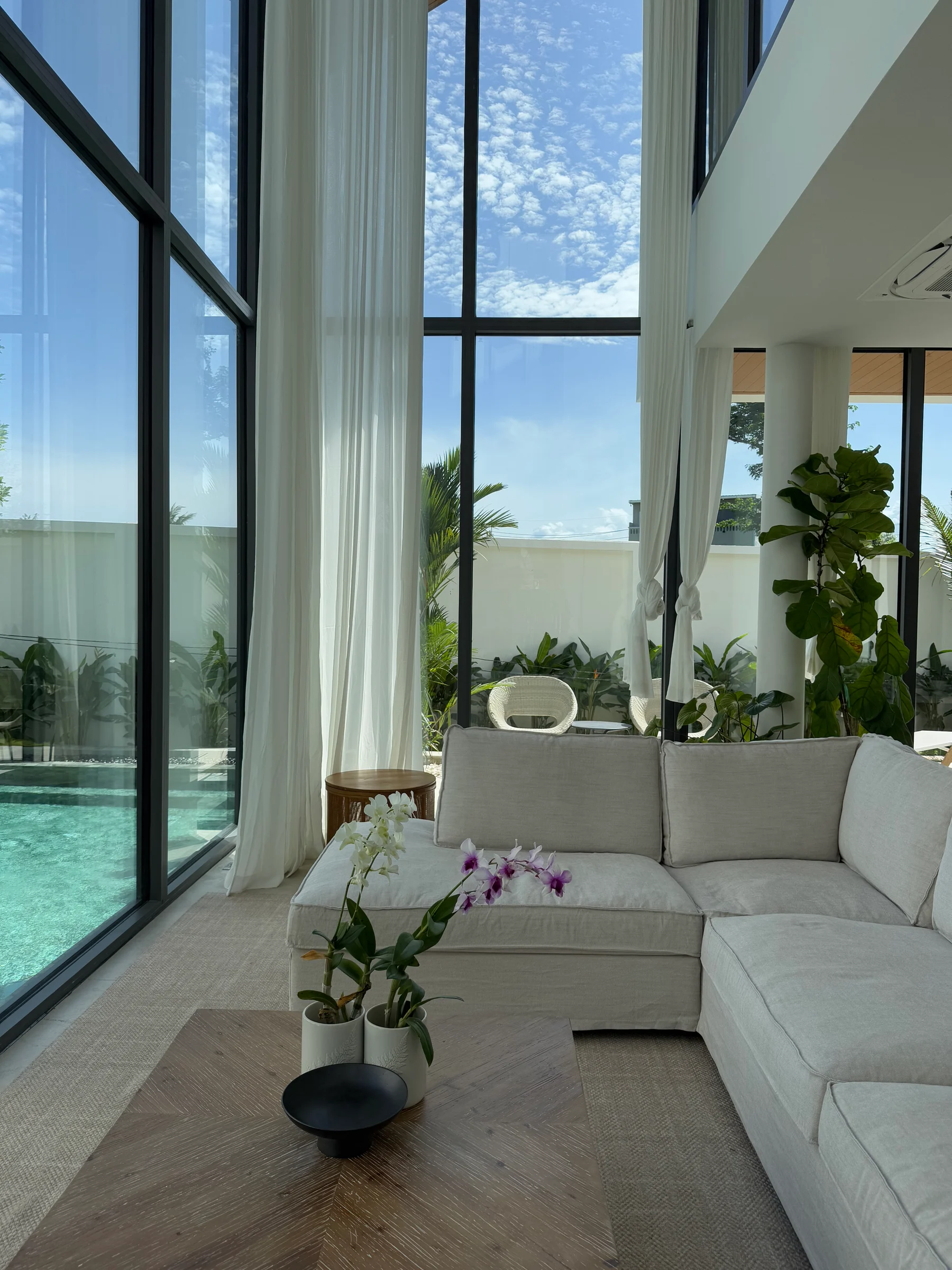 Sunlit living room beside the pool