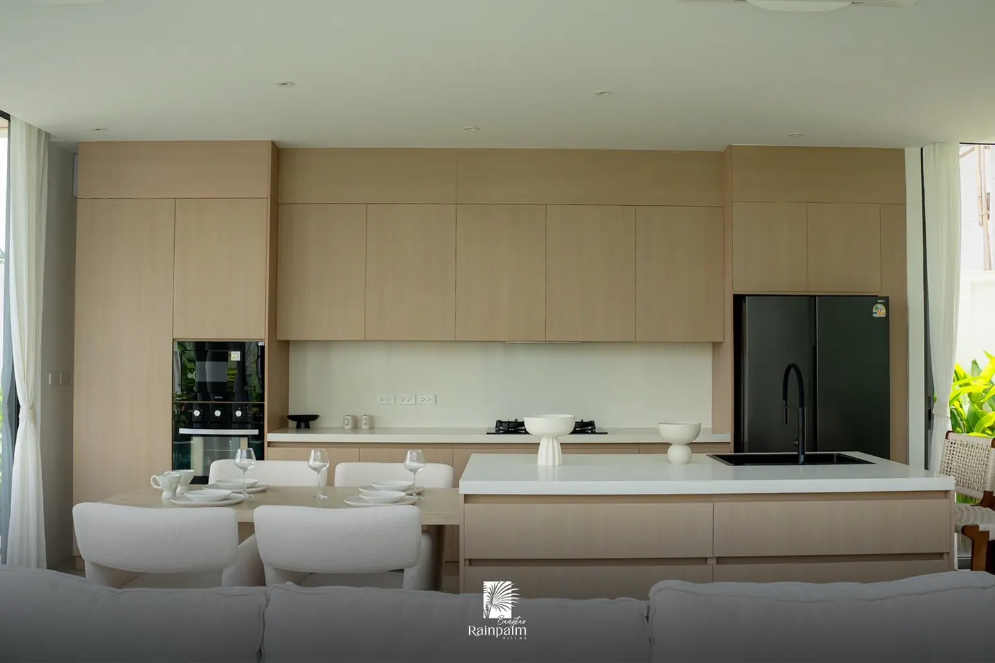 Kitchen with island and built-in appliances