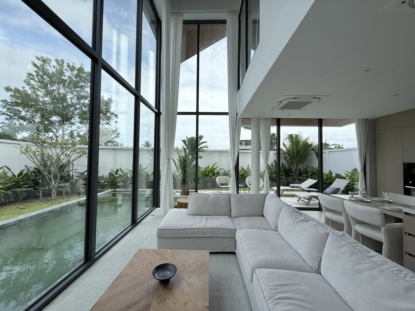 Living room with a large sofa and the kitchen beyond